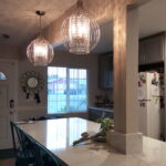 two chandeliers over kitchen island